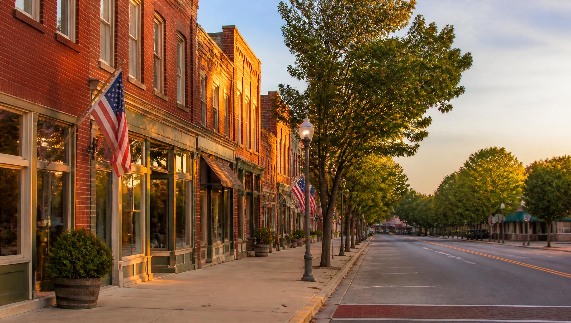 Historic brick storefronts along High Street in downtown Covington at sunset